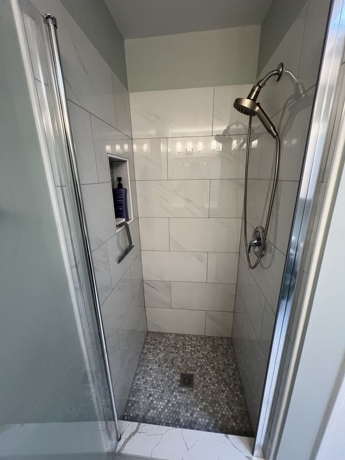 Finished tiled shower with glass door