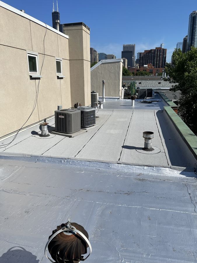 Newly coated flat roof with rooftop AC unit