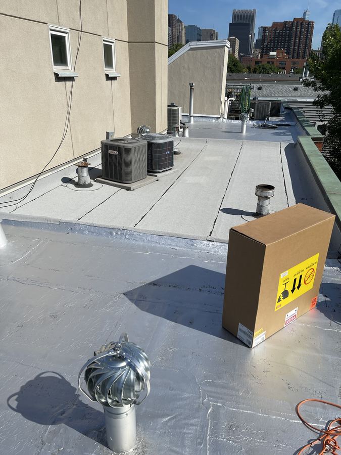 Flat roof coating with drain and skylights